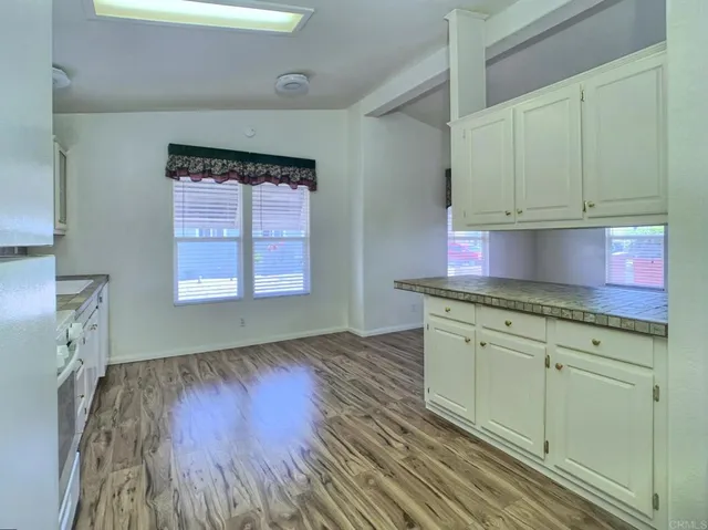 a kitchen with granite countertop wooden floors granite top and sink
