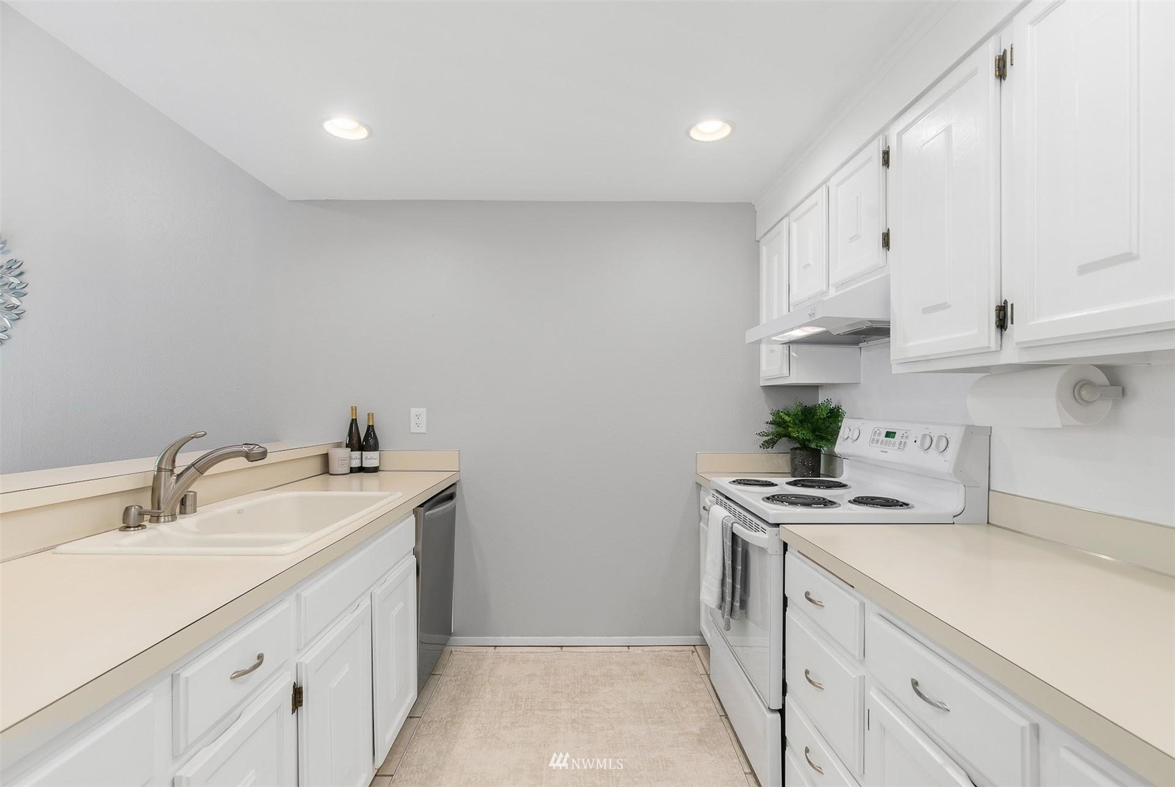 7491 Old Redmond Road, Unit 420 Redmond, WA 98052 - Photo 12 of 25 a kitchen with stainless steel appliances a sink stove and cabinets