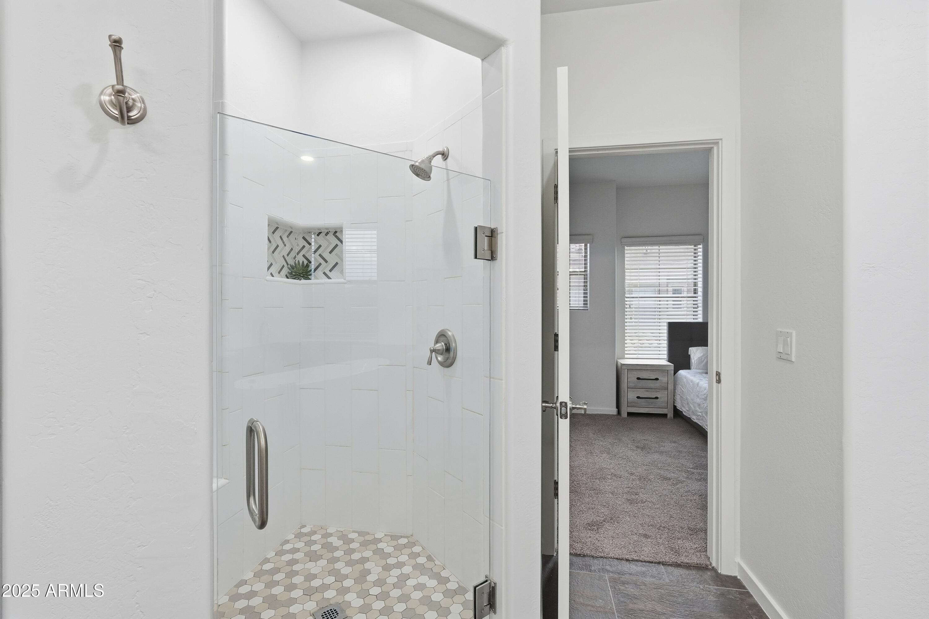 3935 East Rough Rider Road, Unit 1140 Phoenix, AZ 85050 - Photo 11 of 24 a view of a bedroom from a hallway