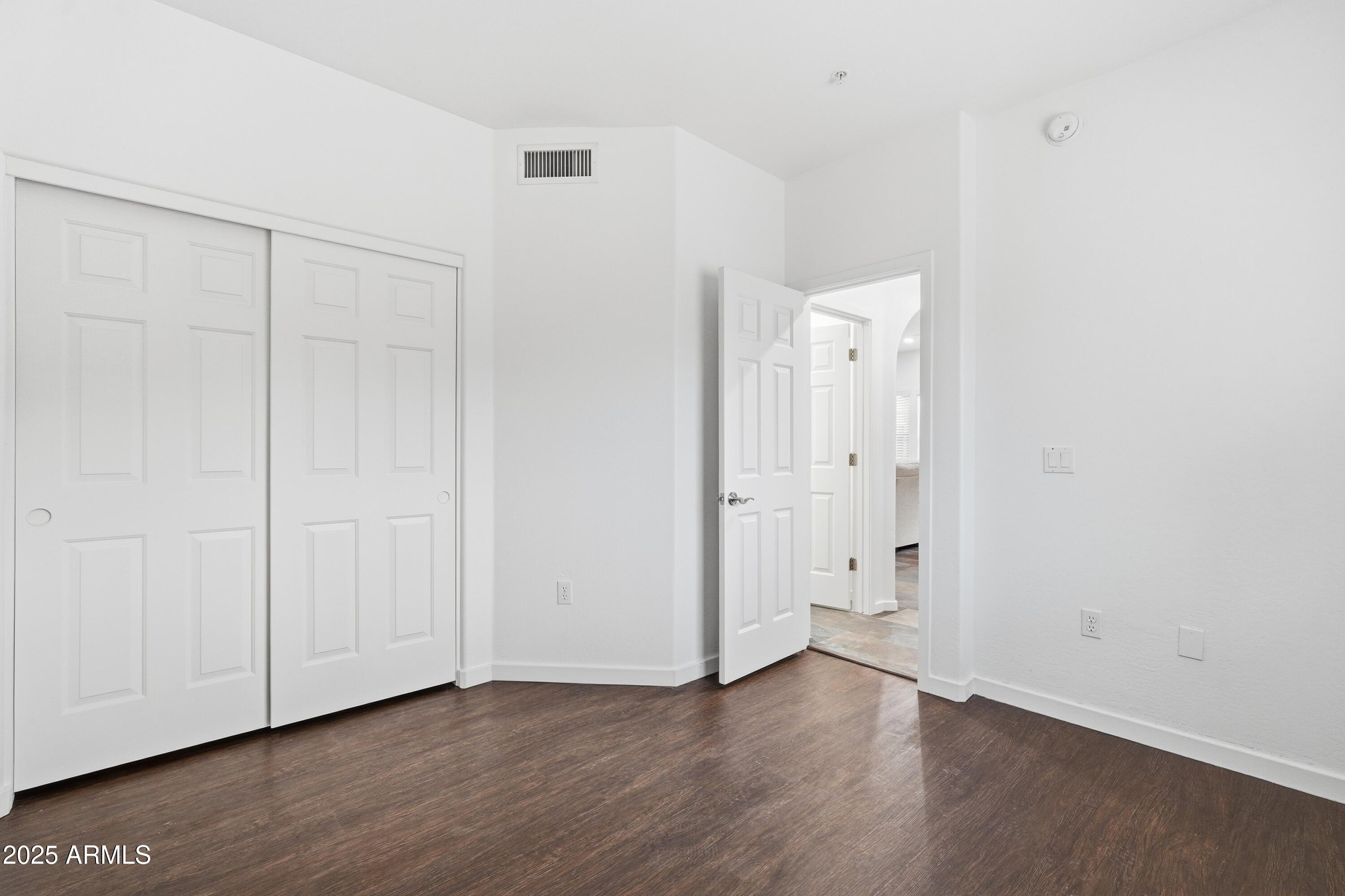 3935 East Rough Rider Road, Unit 1140 Phoenix, AZ 85050 - Photo 13 of 24 a view of an empty room with closet and a window