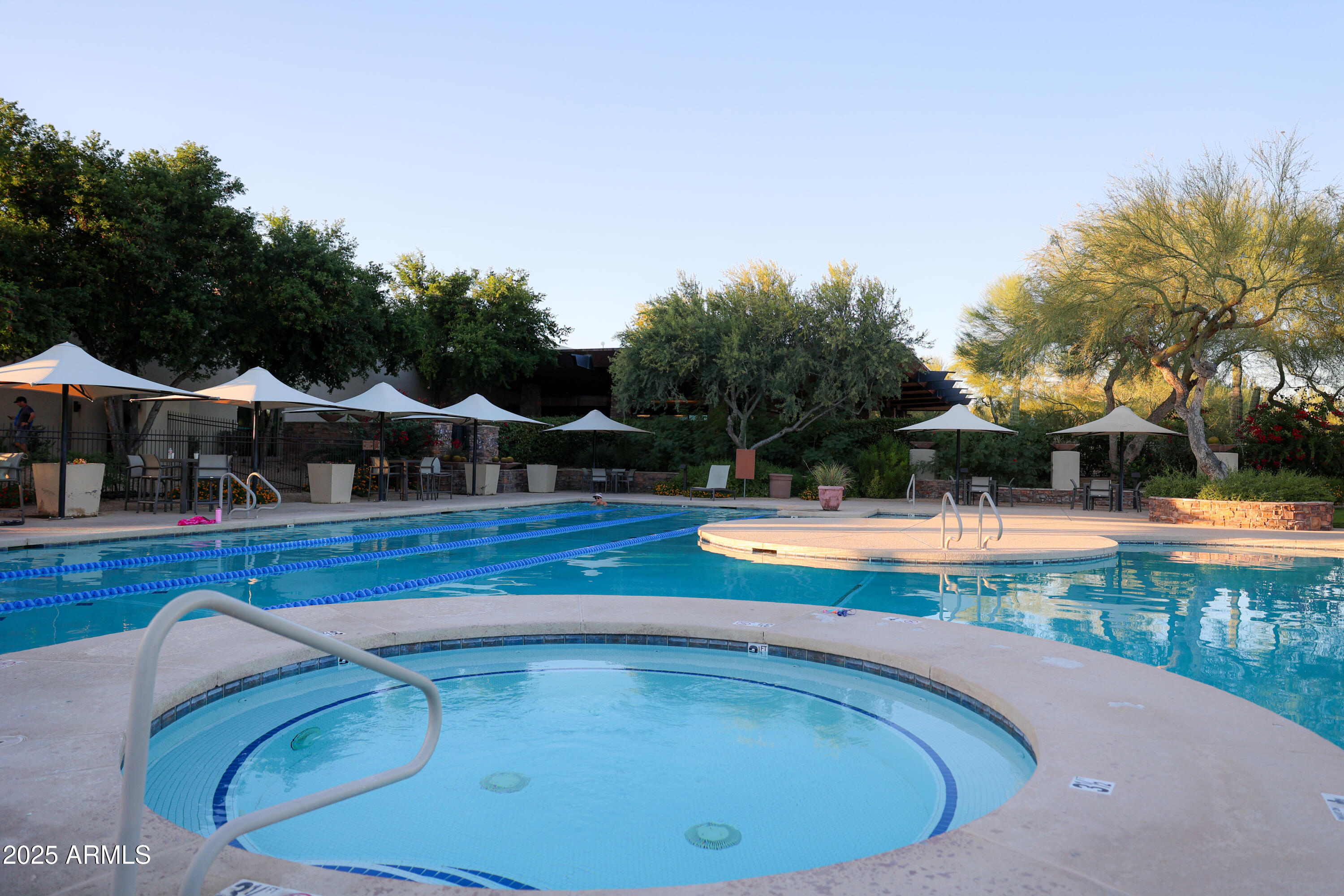 3935 East Rough Rider Road, Unit 1140 Phoenix, AZ 85050 - Photo 18 of 24 a view of swimming pool and outdoor seating