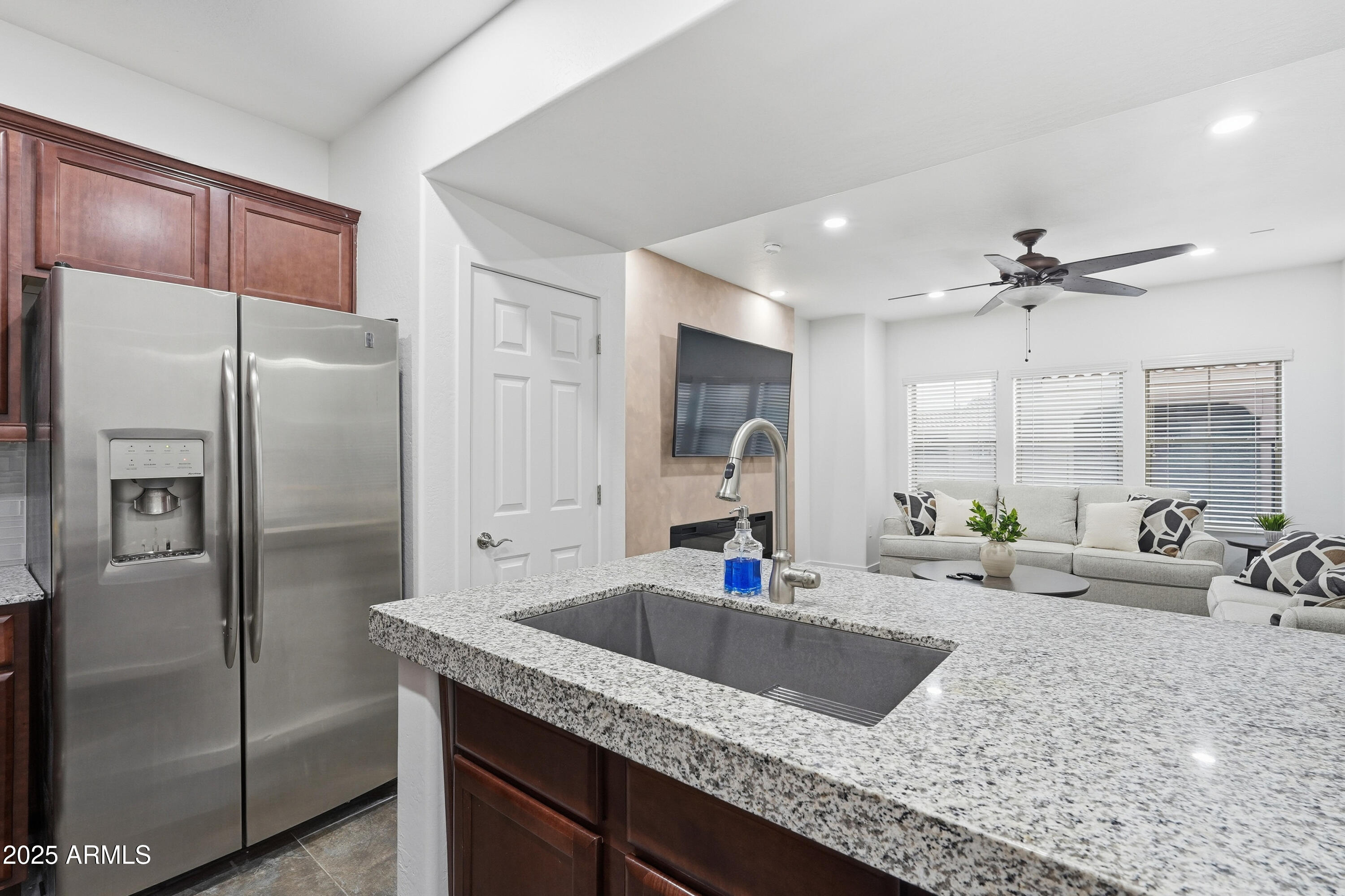 3935 East Rough Rider Road, Unit 1140 Phoenix, AZ 85050 - Photo 3 of 24 a kitchen with granite countertop a sink and refrigerator