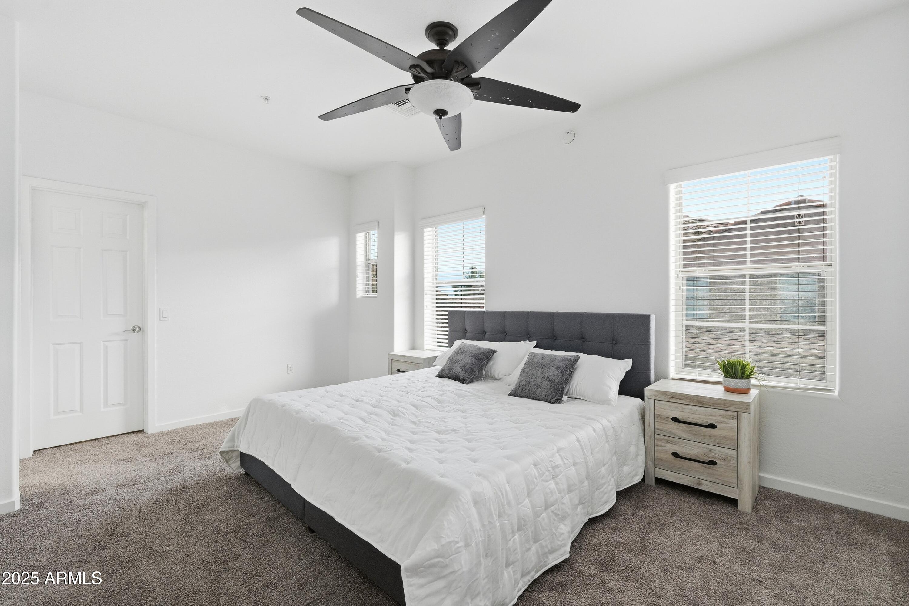 3935 East Rough Rider Road, Unit 1140 Phoenix, AZ 85050 - Photo 8 of 24 a bedroom with a bed a chandelier and a window