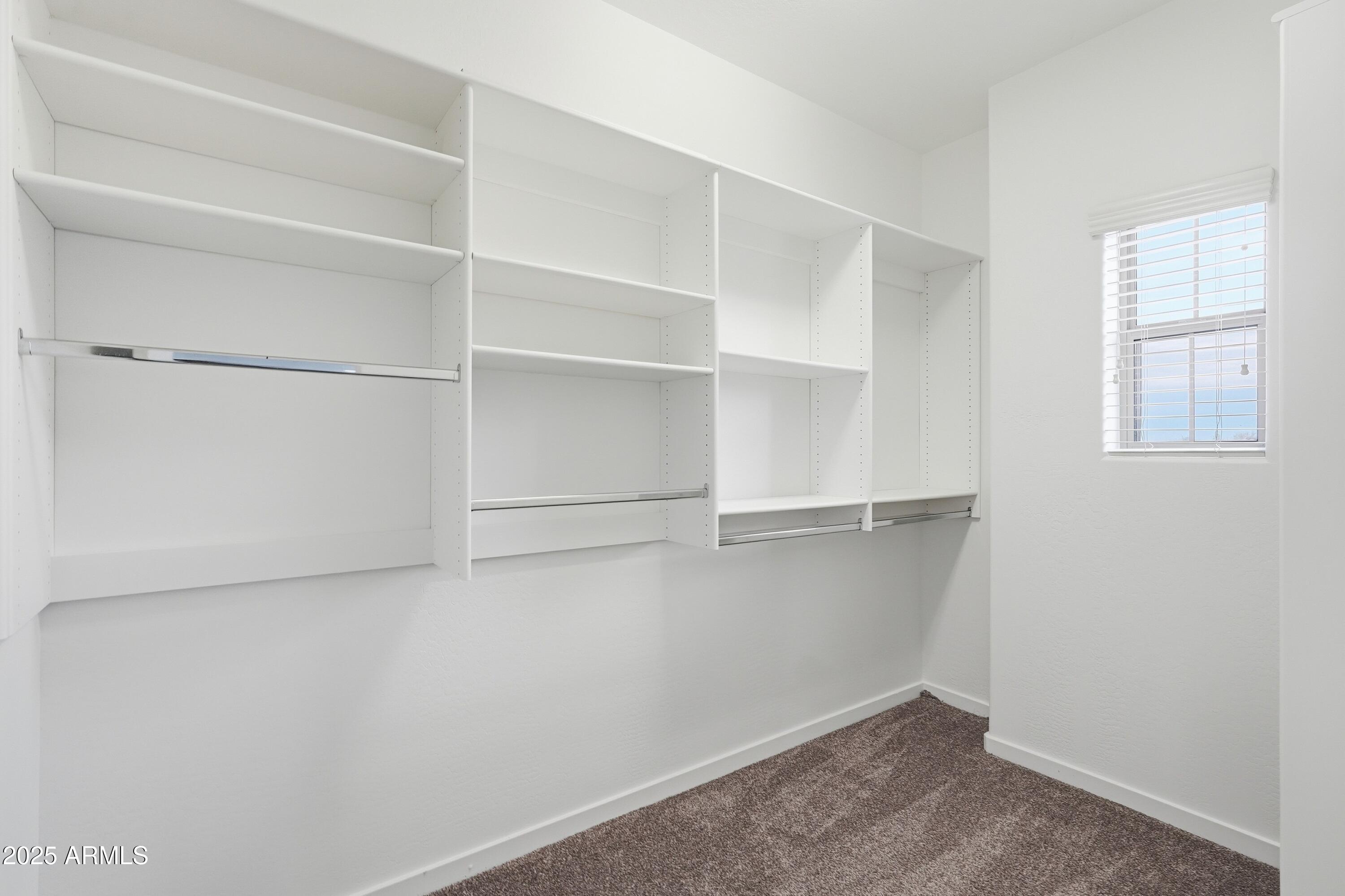 3935 East Rough Rider Road, Unit 1140 Phoenix, AZ 85050 - Photo 10 of 24 a view of an empty walk in closet