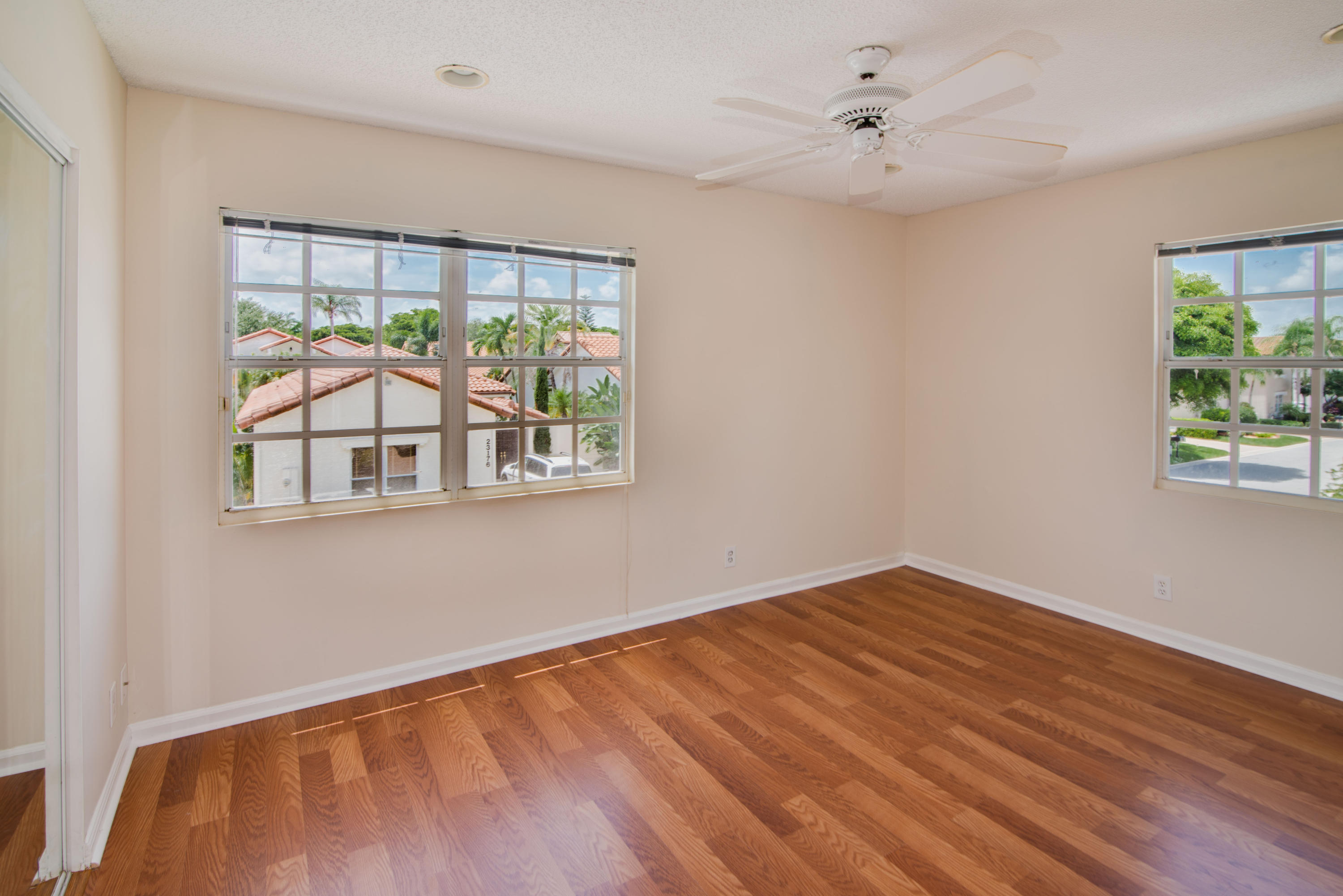 23177 Via Stel Boca Raton, FL 33433 - Photo 26 of 34 a view of an empty room with wooden floor and a window