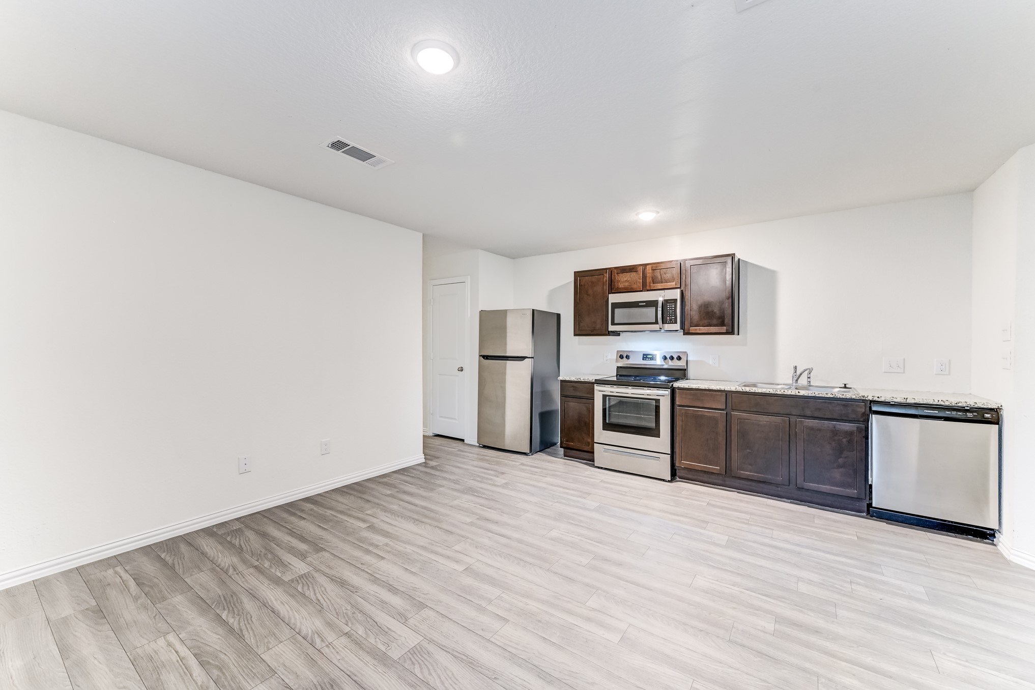 7925 Way Street, Unit A Houston, TX 77028 - Photo 8 of 29 a kitchen with stainless steel appliances a refrigerator and a stove top oven