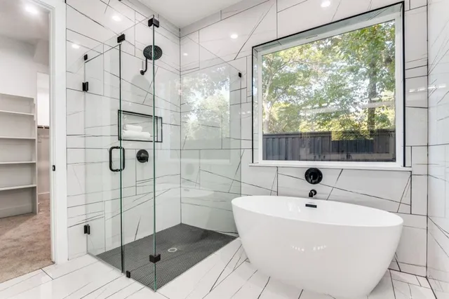 a bathroom with a bathtub and shower