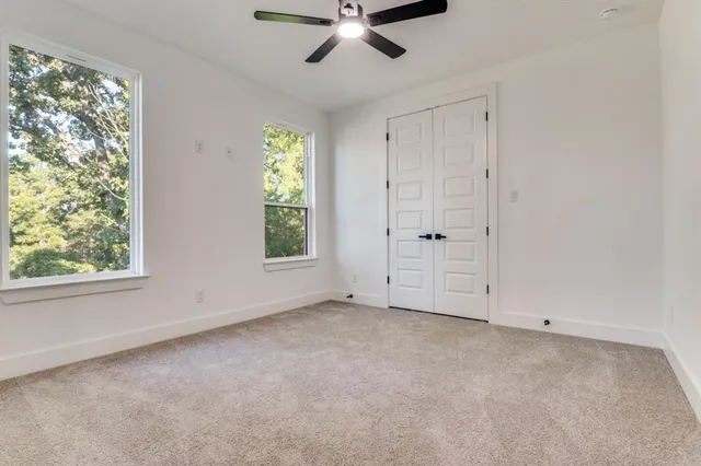 an empty room with windows and closet