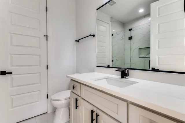 a bathroom with a sink toilet vanity and tub