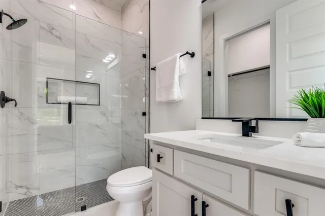 a bathroom with a sink toilet and shower
