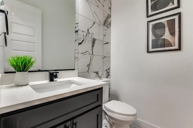 a bathroom with a sink a toilet and mirror
