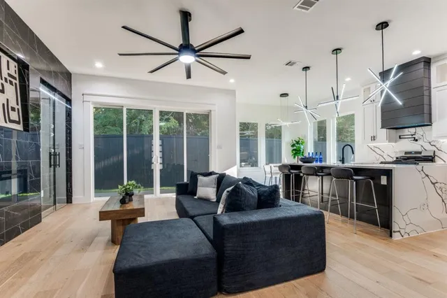a living room with furniture fireplace and a large window