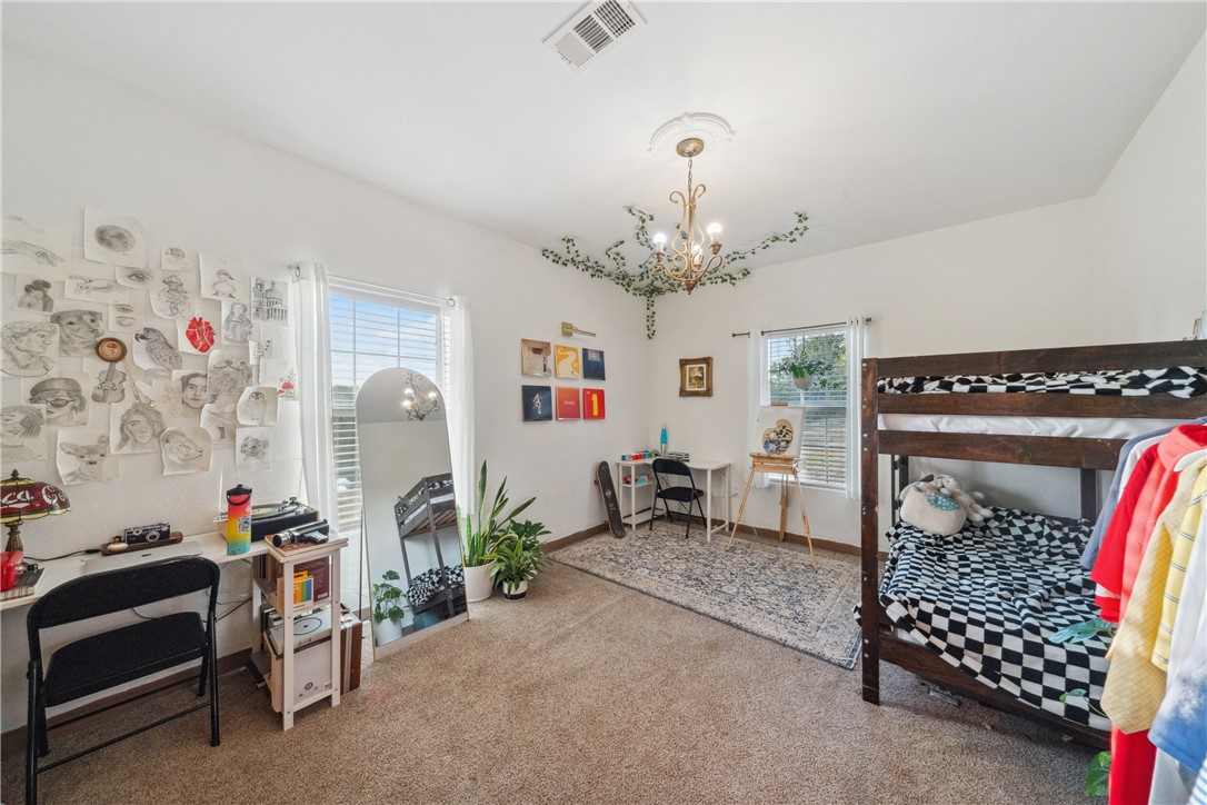 740 Bridget Avenue Buffalo, TX 75831 - Photo 20 of 42 a bedroom with furniture and a chandelier