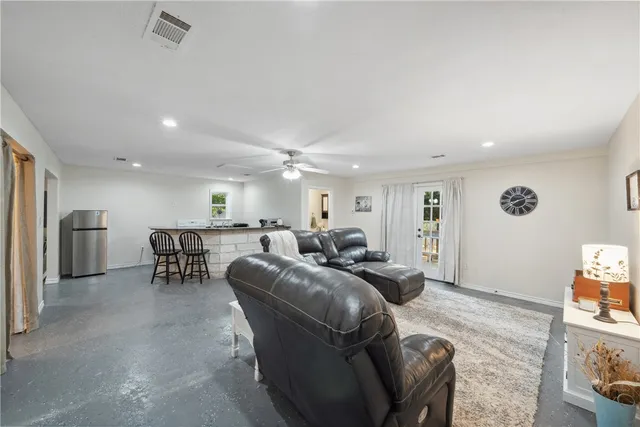 a view of a chair and table in the back yard of the house