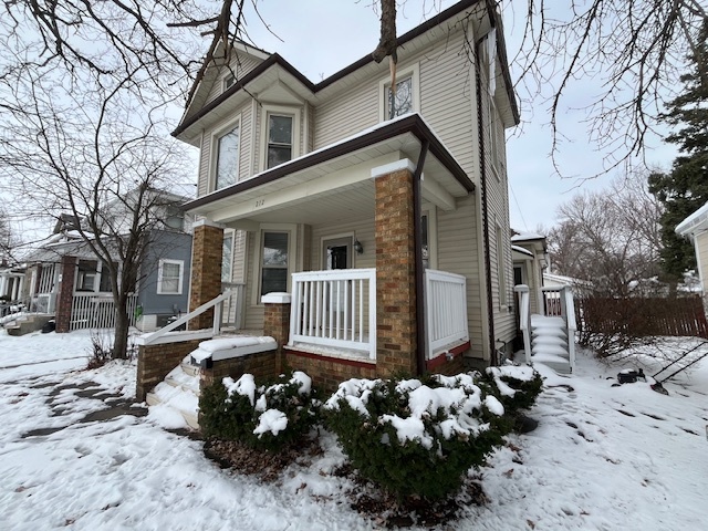 212 Washington Street Streator, IL 61364 - Photo 2 of 5 a front view of a house with a yard covered in snow