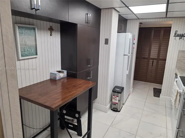 a kitchen with a stove sink and cabinets