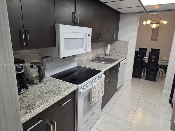 a white refrigerator freezer sitting inside of a kitchen