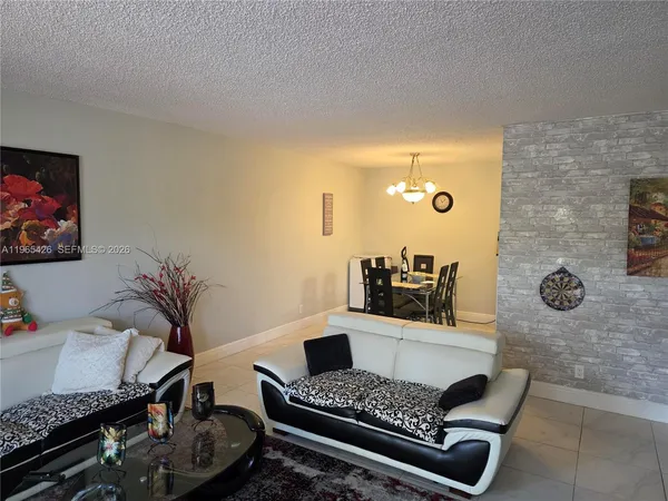 a view of a dining room with furniture and a chandelier