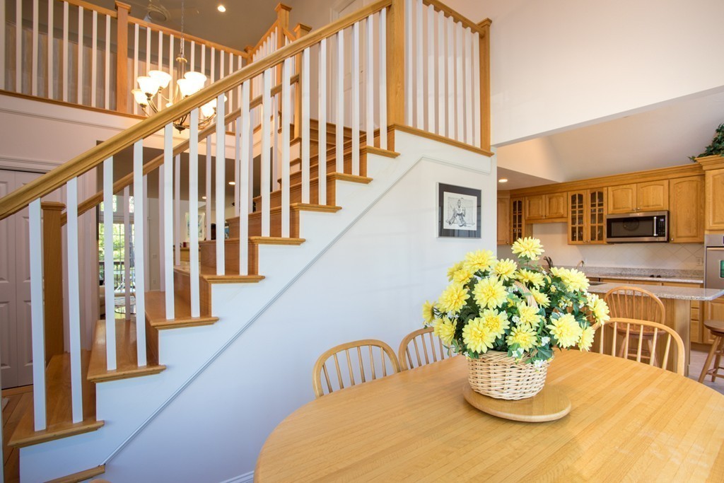 64 Gold Leaf Lane, Unit 64 Mashpee, MA 02649 - Photo 11 of 28 a view of a dining room with furniture and a potted plant