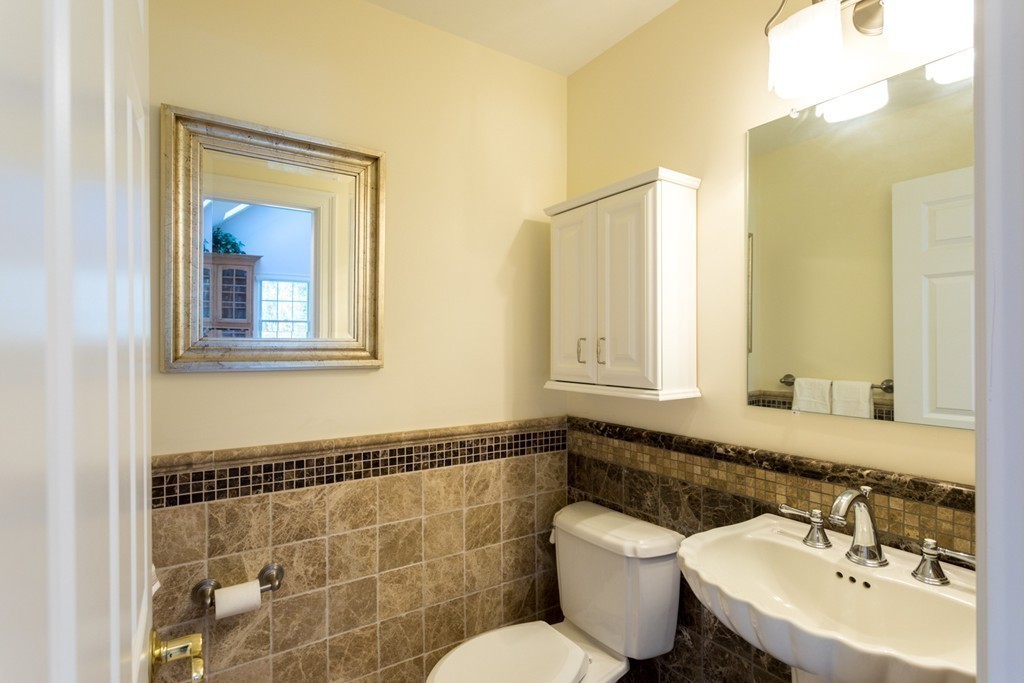 64 Gold Leaf Lane, Unit 64 Mashpee, MA 02649 - Photo 12 of 28 a bathroom with a sink and a mirror