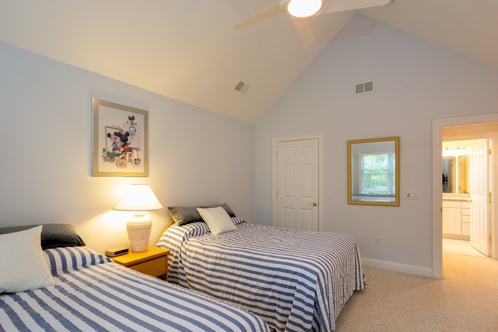 64 Gold Leaf Lane, Unit 64 Mashpee, MA 02649 - Photo 18 of 28 a bedroom with a bed and wooden floor