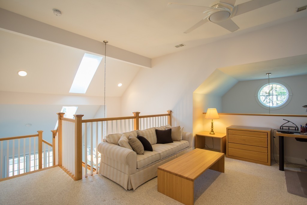 64 Gold Leaf Lane, Unit 64 Mashpee, MA 02649 - Photo 20 of 28 a living room with furniture and a night stand