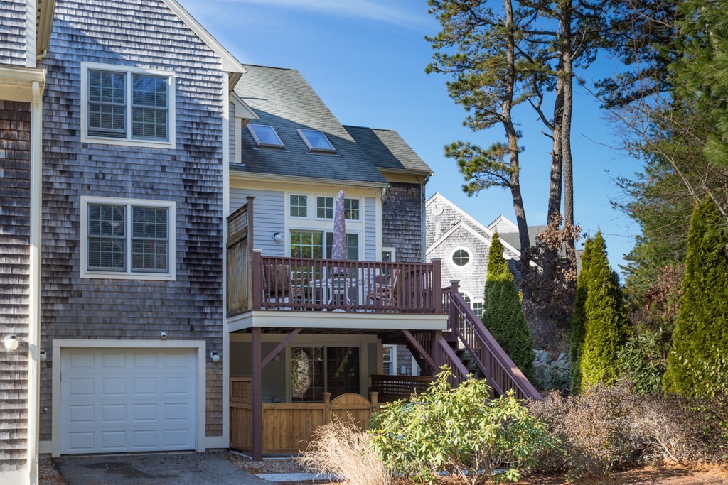 64 Gold Leaf Lane, Unit 64 Mashpee, MA 02649 - Photo 2 of 28 a front view of a house with garden