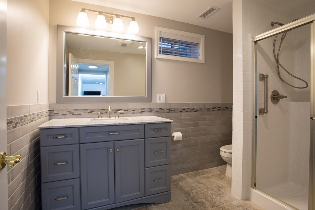 64 Gold Leaf Lane, Unit 64 Mashpee, MA 02649 - Photo 26 of 28 a bathroom with a granite countertop sink mirror and a toilet