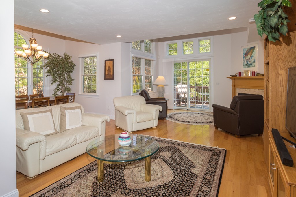 64 Gold Leaf Lane, Unit 64 Mashpee, MA 02649 - Photo 3 of 28 a living room with fireplace furniture and a large window