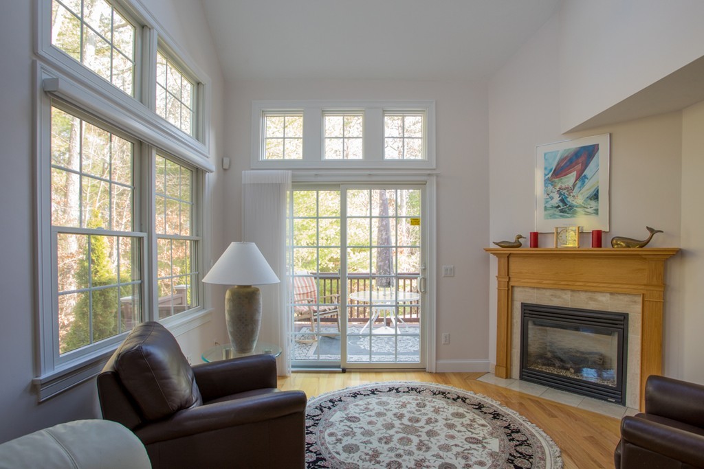 64 Gold Leaf Lane, Unit 64 Mashpee, MA 02649 - Photo 4 of 28 a living room with furniture and a fireplace