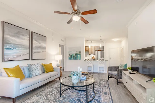 a living room with furniture a rug and a chandelier