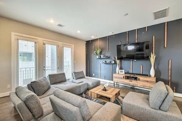 a living room with furniture and a flat screen tv
