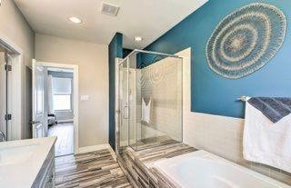 2403 Everett Street, Unit C Houston, TX 77009 - Photo 7 of 11 a spacious bathroom with a large mirror and a shower