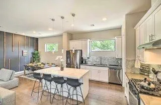 a large kitchen with a table and chairs