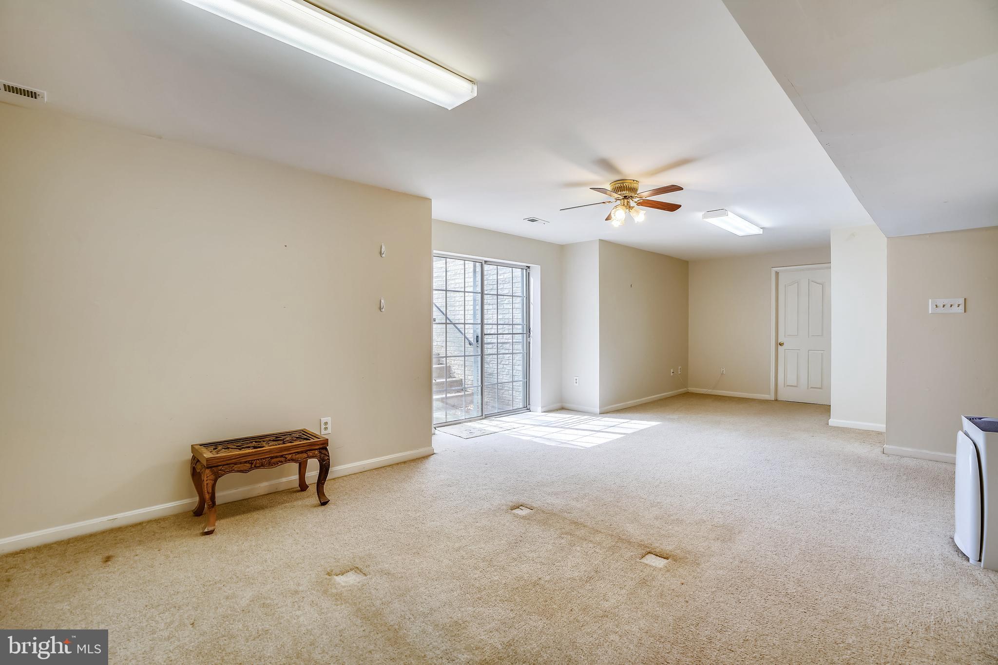 8004 Big Pool Road Laurel, MD 20724 - Photo 28 of 39 an empty room with windows and ceiling fan
