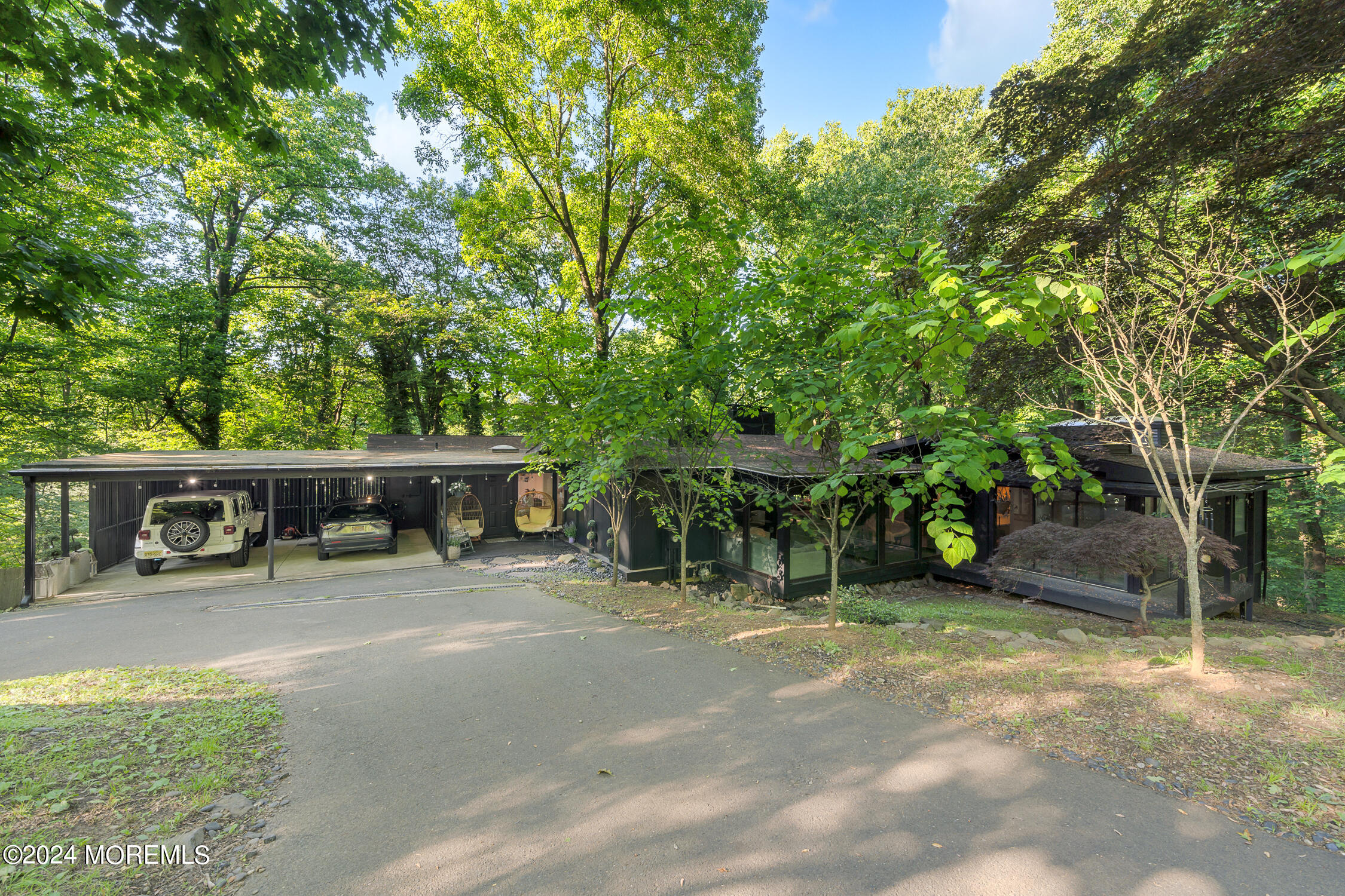 77 Telegraph Hill Road Holmdel, NJ 07733 - Photo 3 of 31 a view of a patio with table and chairs and a large tree