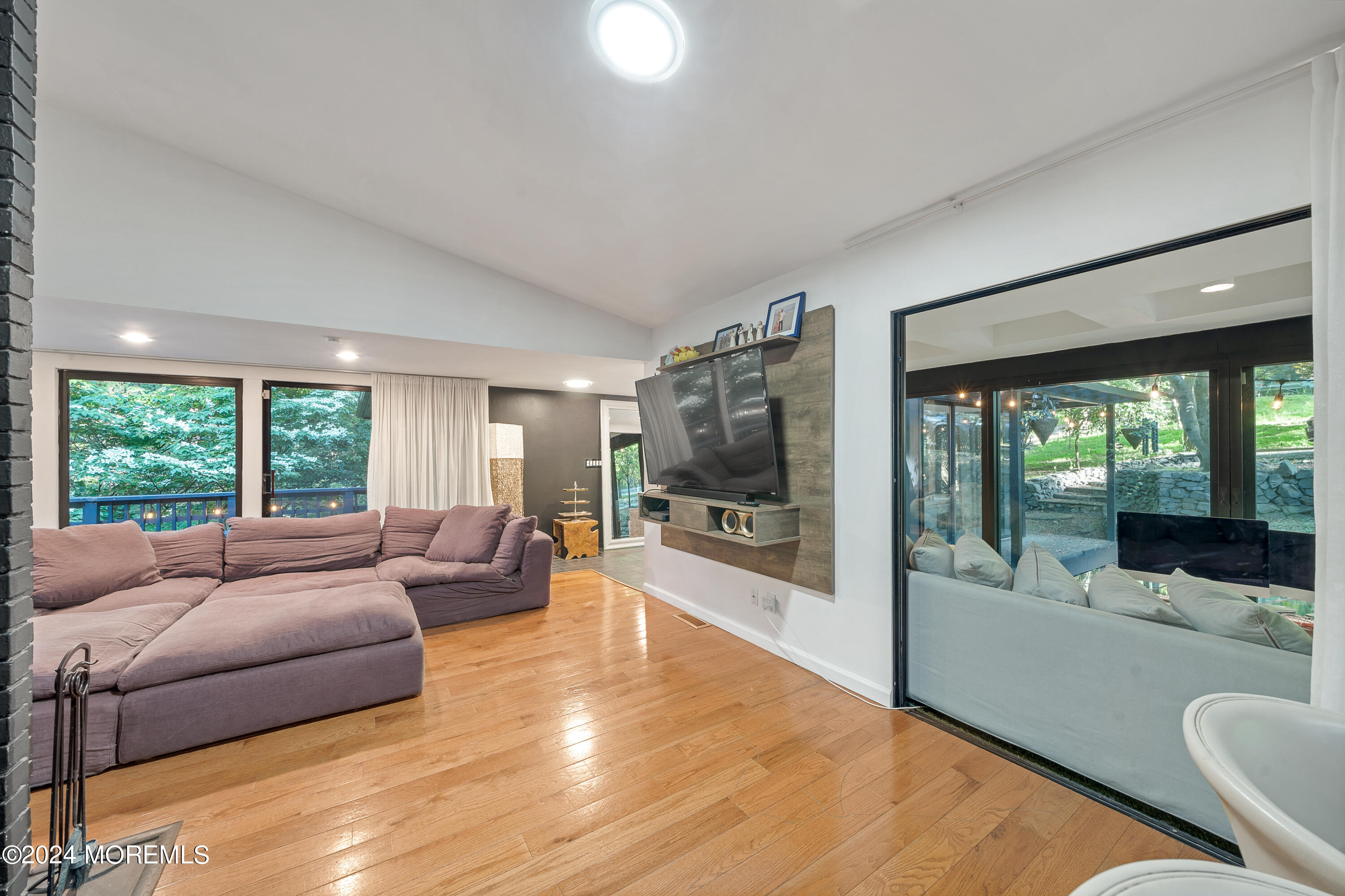 77 Telegraph Hill Road Holmdel, NJ 07733 - Photo 9 of 31 a living room with furniture and a flat screen tv