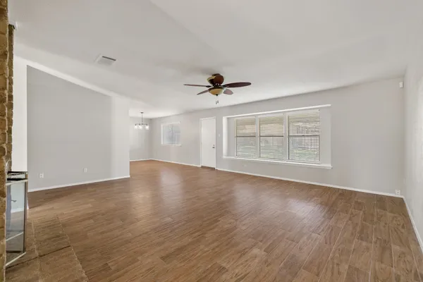 wooden floor fireplace and natural light in room