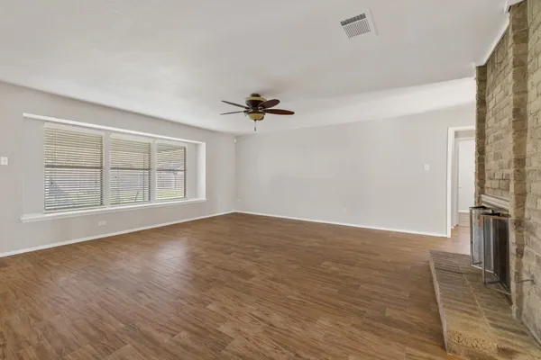 a kitchen with granite countertop a sink a stove and cabinets