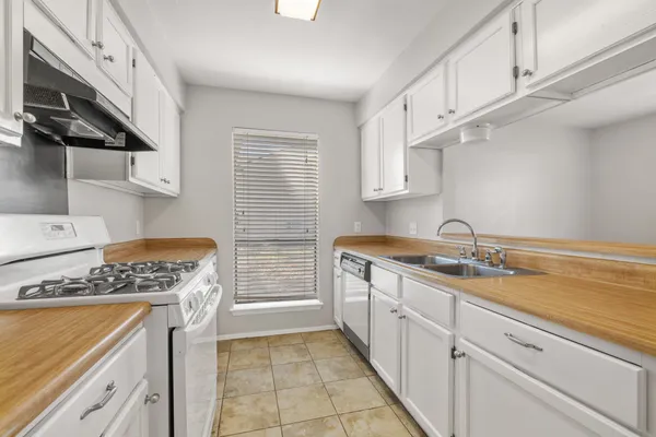 a view of a kitchen with a sink cabinets and wooden floor