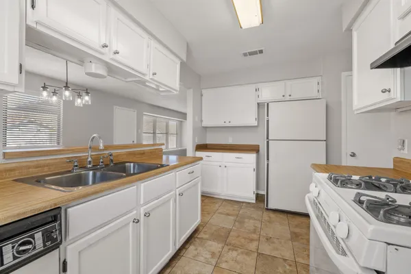 a view of a kitchen with wooden floor and a sink