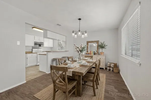 a view of a house with a yard and a large tree