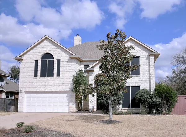 a view of a house with a yard and garage