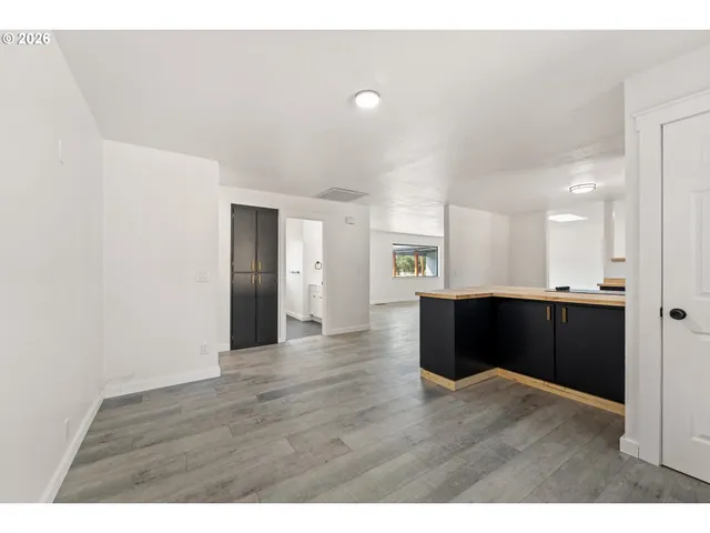 a view interior of kitchen and hall with wooden floor