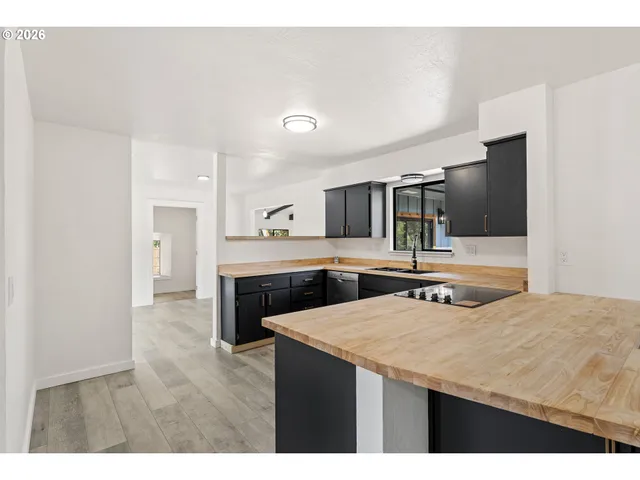 a kitchen with stainless steel appliances a sink and a refrigerator
