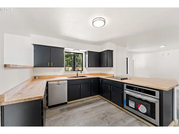 a kitchen with a sink stove and cabinets