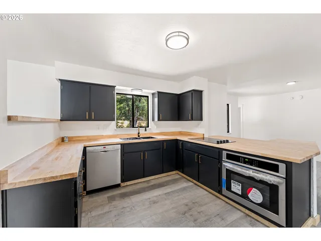 a kitchen with a sink stove and cabinets