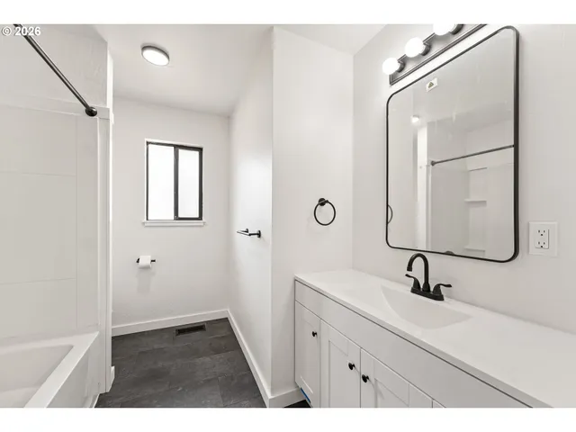 a bathroom with a sink a mirror and shower