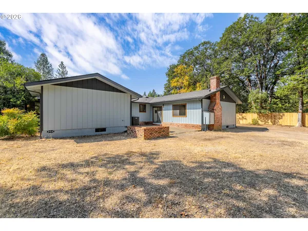 a house with trees in the background