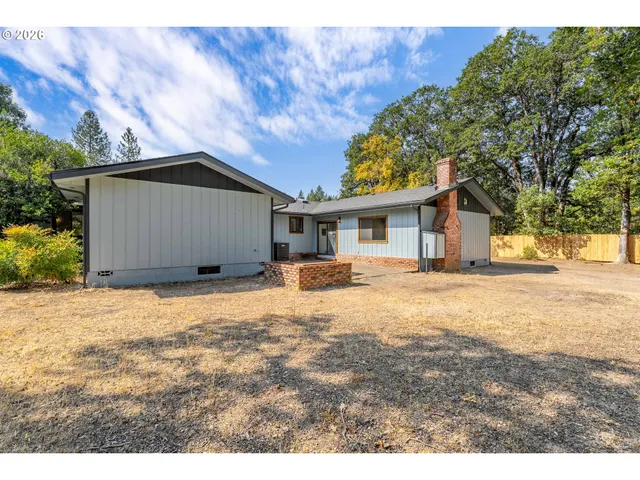 a house with trees in the background